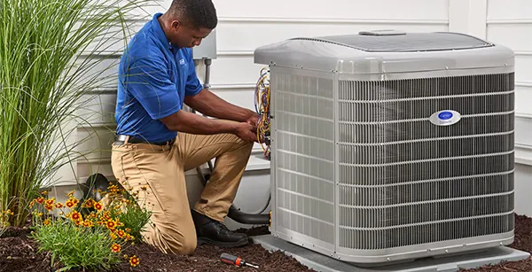HVAC technician repairing an outdoor heat pump to restore efficient performance